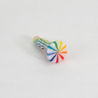 Colorful striped glass joystick accessory on white background