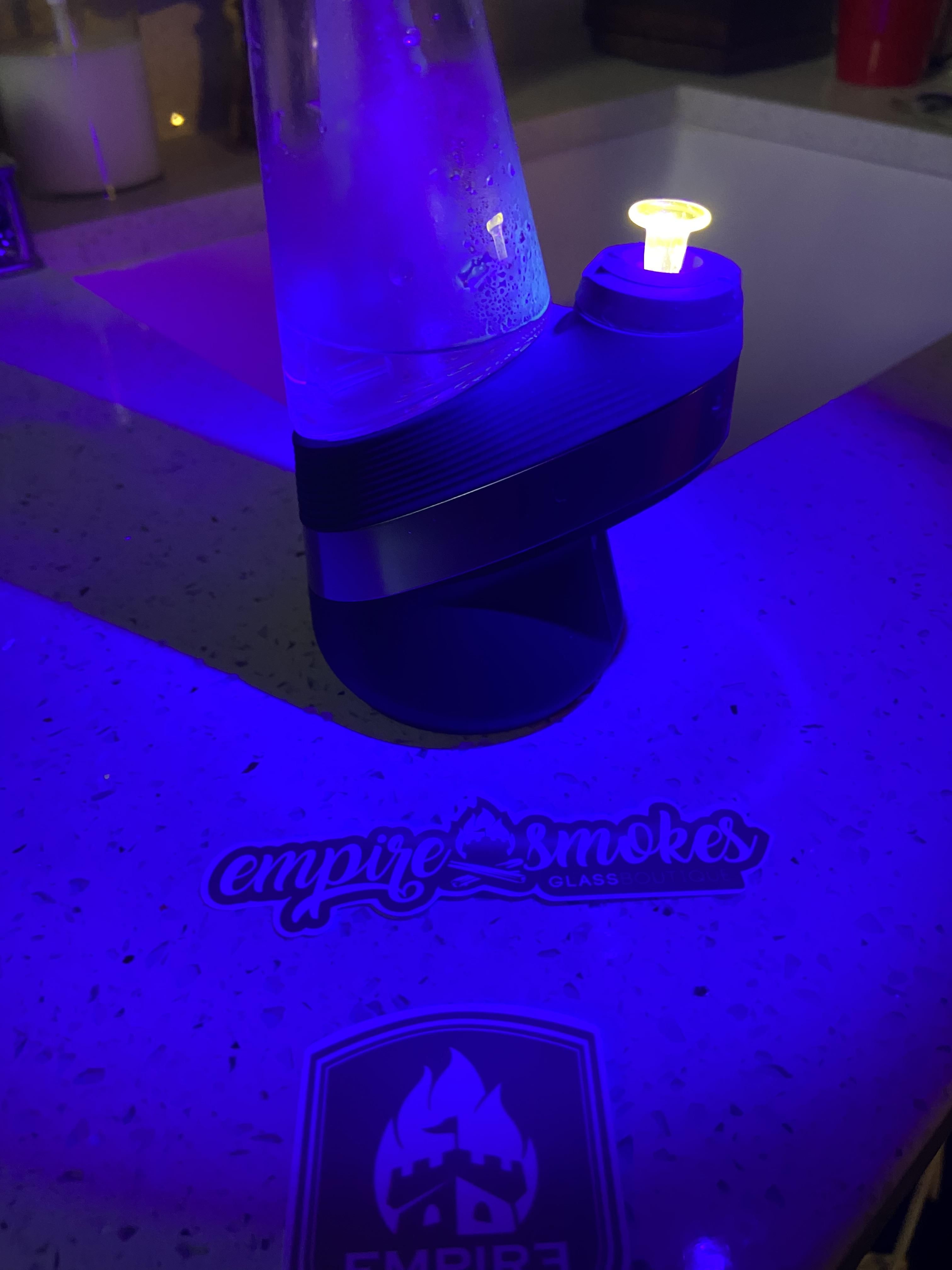 A Puffco peak device with a UV yellow joystick cap