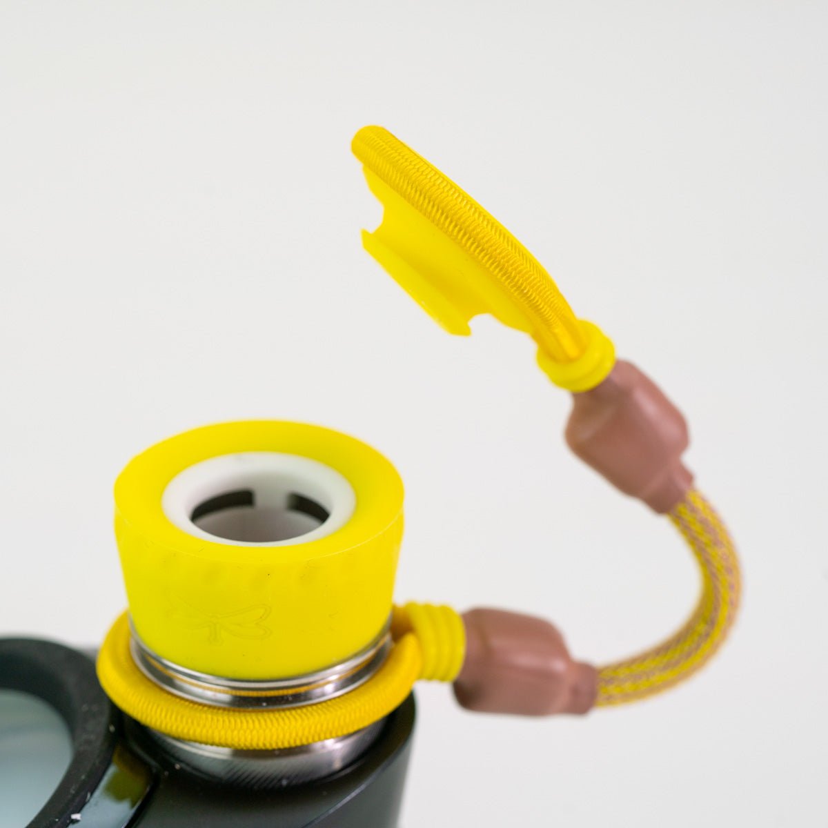 Yellow attachment on Puffco device with opened top