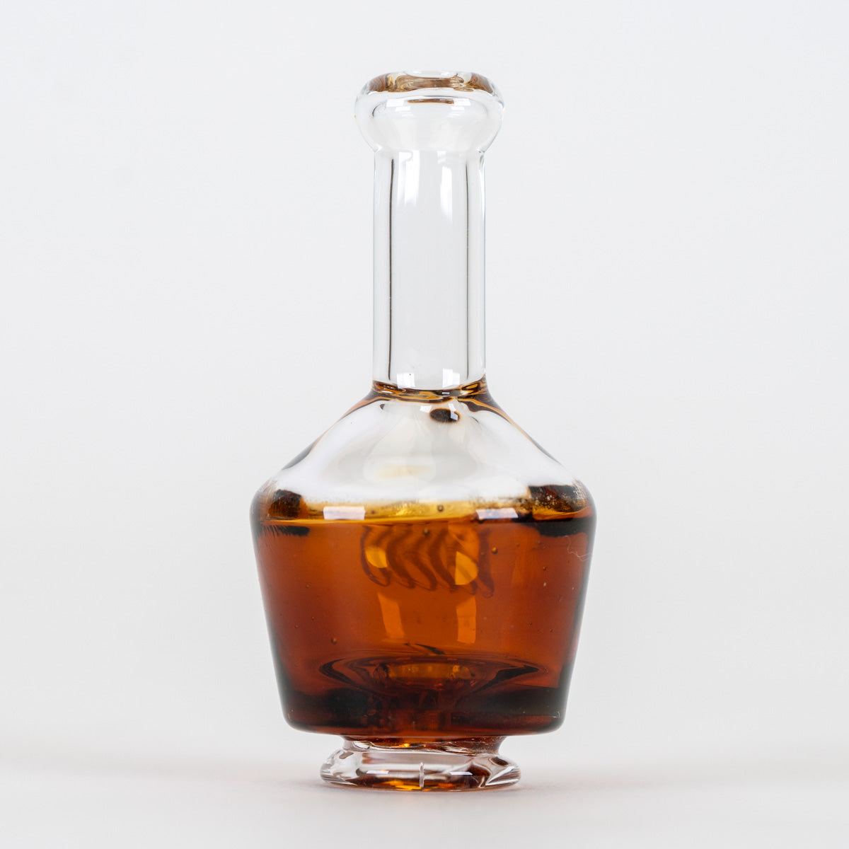 Amber Puffco Pivot mouthpiece with clear neck and collectible glass artwork