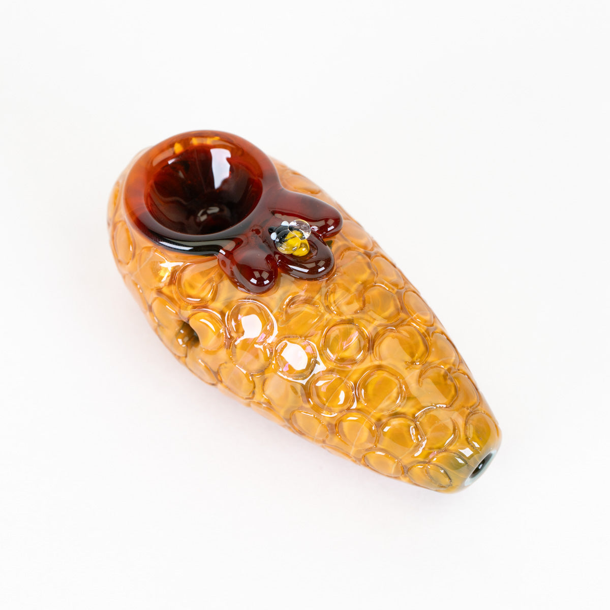 Honey inspired glass pipe with small bee details on a white background