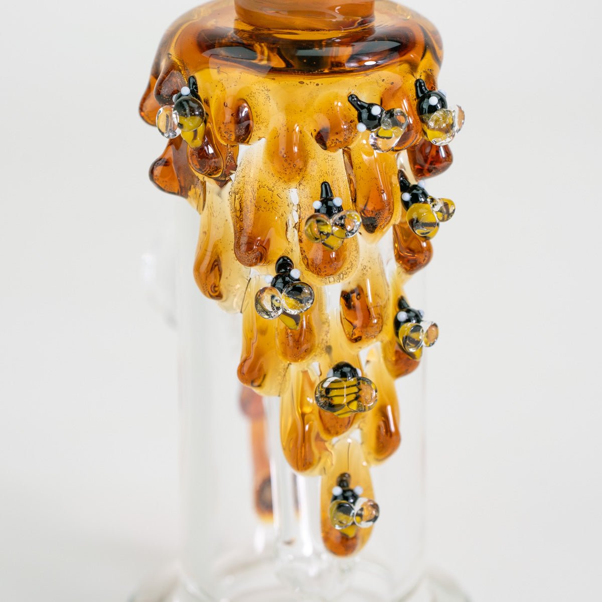 Closeup of nano rig with bees on dripping honey
