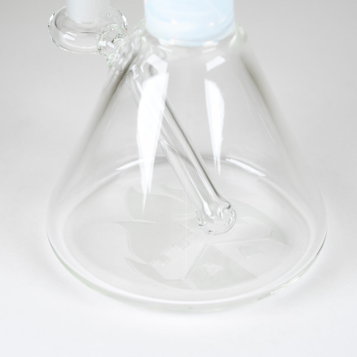 Interior view of the permanently integrated glass downstem inside the clear borosilicate base of the Celeste Signature Beaker