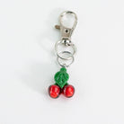 Glass Puffco keychain with cherry design on a white background