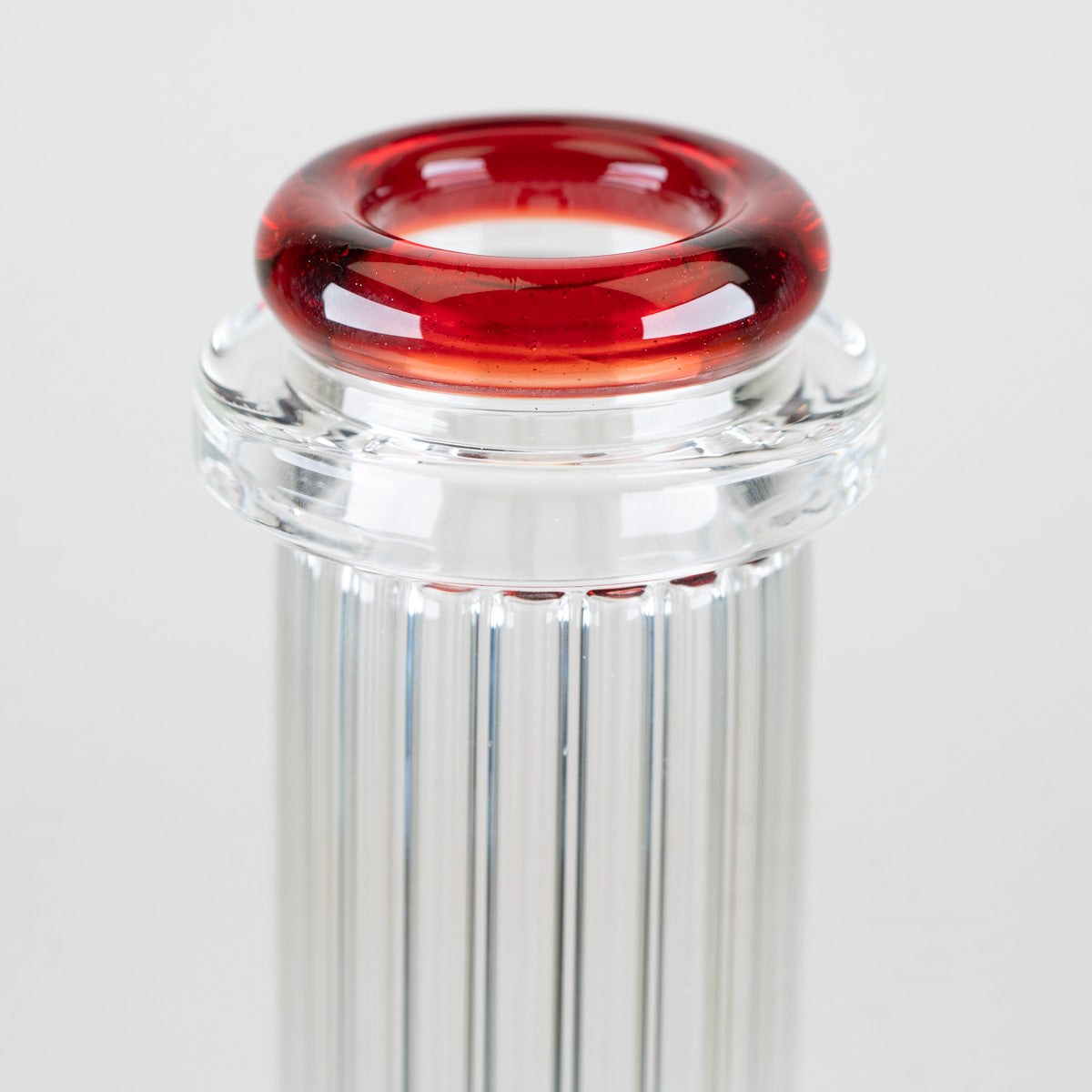 Close-up of the sculpted ruby-red comfort rim mouthpiece and clear glass collar on the Empire Glassworks Classics Beaker