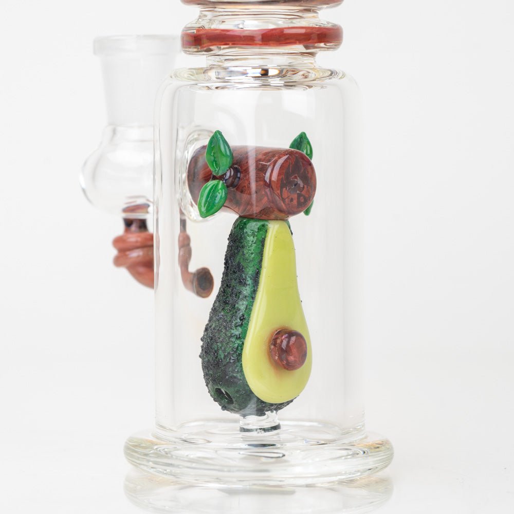 A close up of the glass avocado dab rig with upright mini tube body and side joint