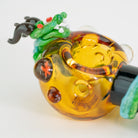 Closeup of glass dragon on small spoon pipe sphere