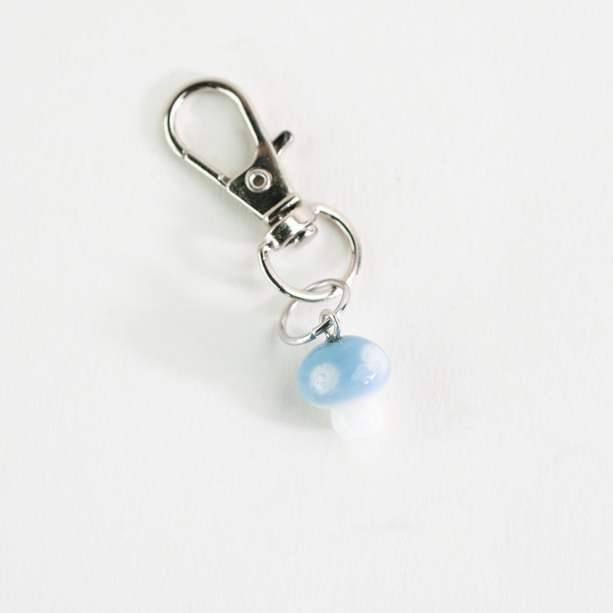 Cute blue mushroom glass charm styled as a Puffco accessory