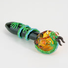 A decorative glass dragon sphere spoon pipe on white background