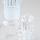Detailed view of the clear ribbed glass bowl beside the soft blue neck accent on the Empire Glassworks Celeste Beaker