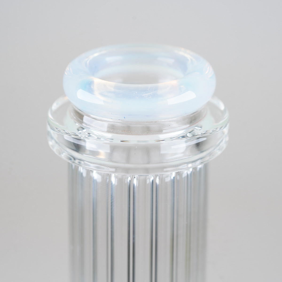 Close-up of the sculpted opalescent blue comfort rim mouthpiece above the clear ribbed neck of the Celeste Beaker Bong