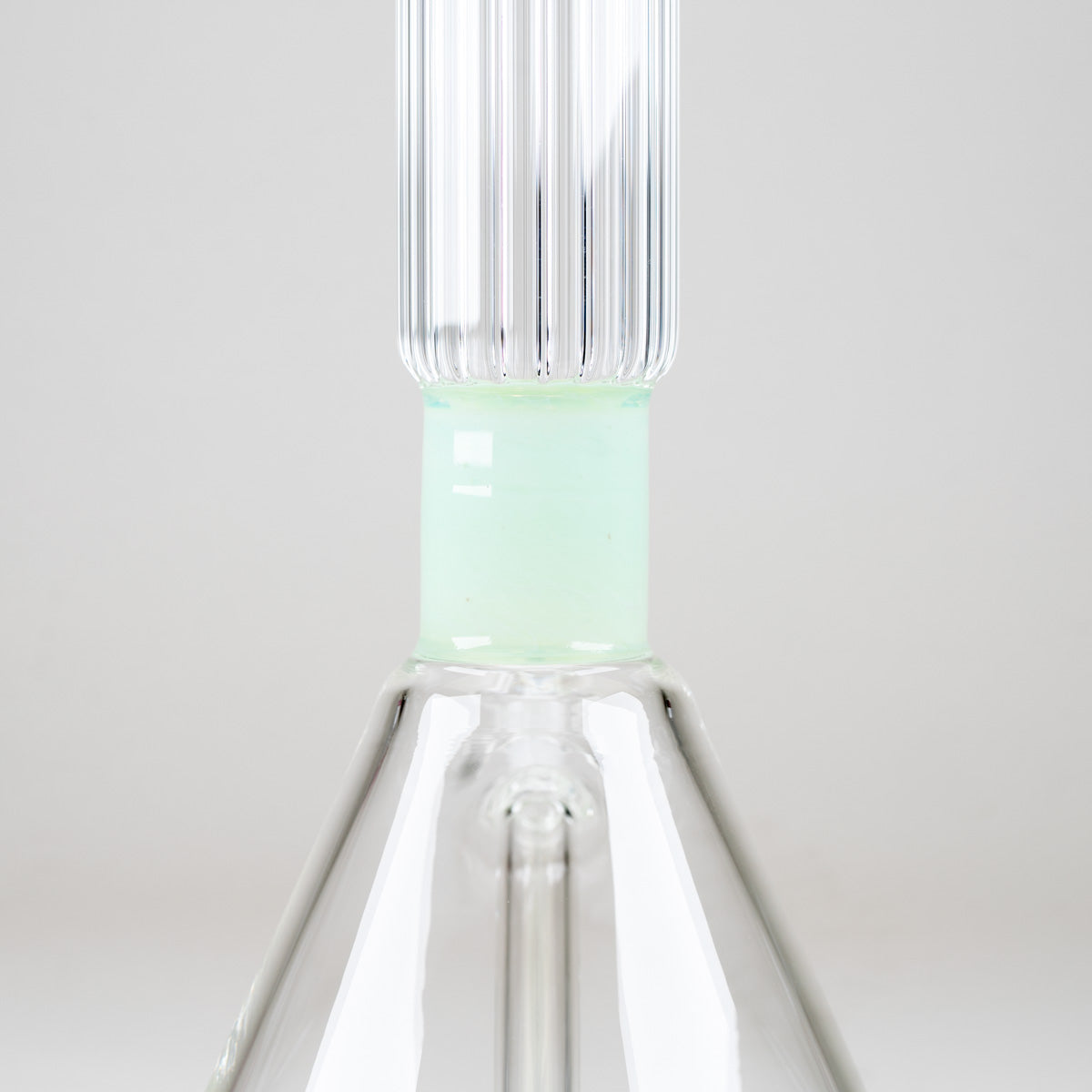 Rear view of the Julep Signature Beaker highlighting its mint-green neck accent and distinctive vertical ribbed glass design