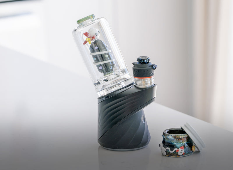 A galactic terp jar and space themed glass attachment for the Puffco Peak Pro included with a black nebula glass joystick cap from Empire Glassworks