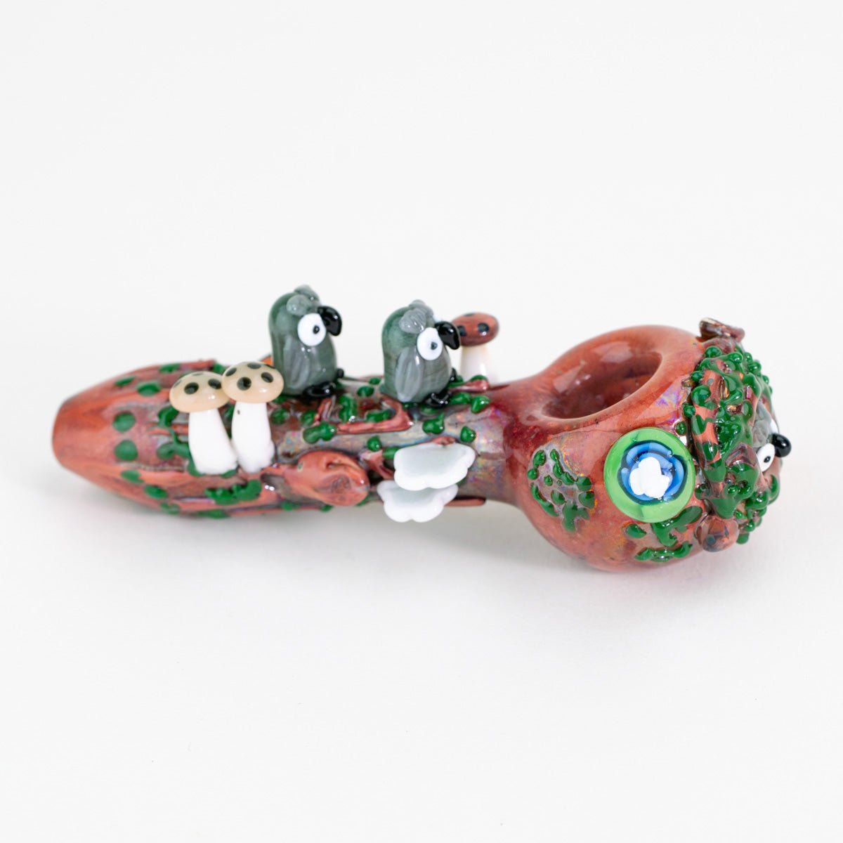 A decorative spoon pipe with owls and nature