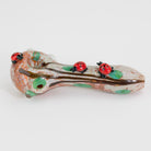 A decorative glass pipe with ladybugs on white background
