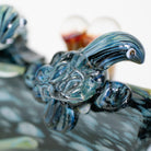 Glass sea turtle figurine on spoon glass pipe