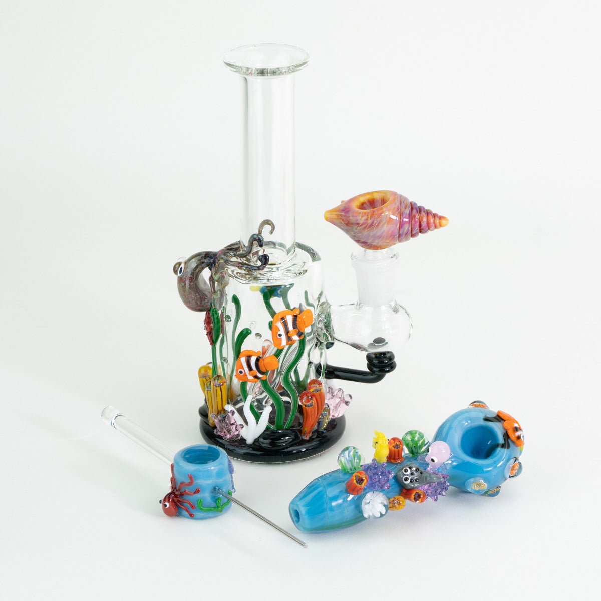 A bundle featuring an under the sea themed mini rig, seashel shaped bowl piece, ocean inspired spoon pipe, and sea themed poker wand