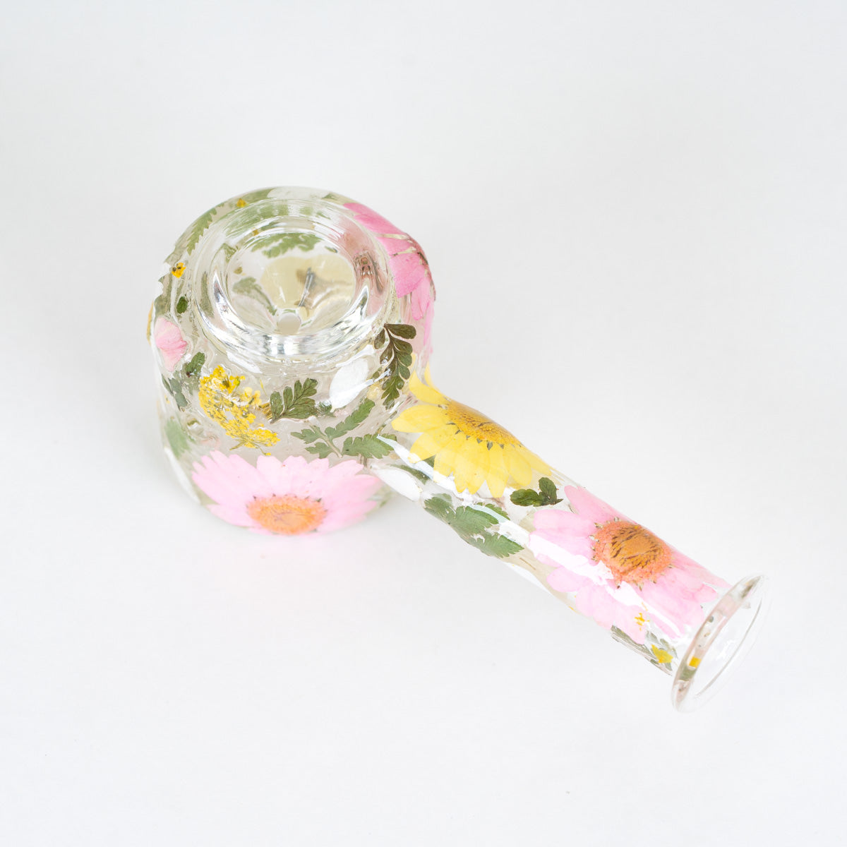 A clear glass water pipe decorated with pressed pink flowers, green leaves, and yellow accents, shown on a plain white background.