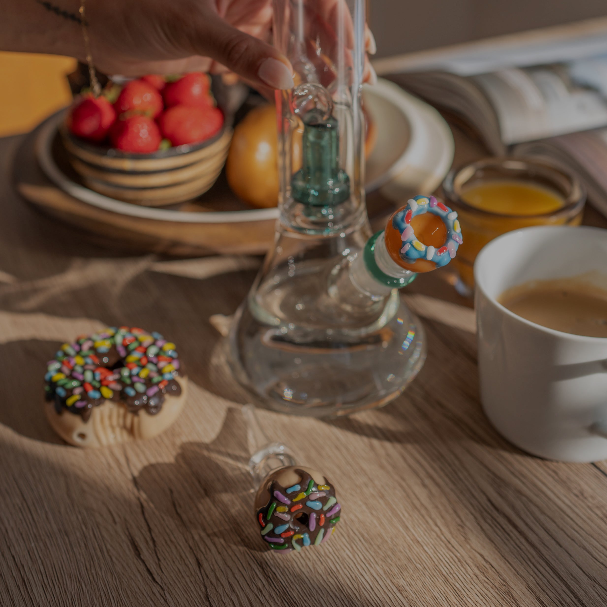 An assortment including a glass bong with a donut bowl piece, a donut dry pipe and a donut honeystraw