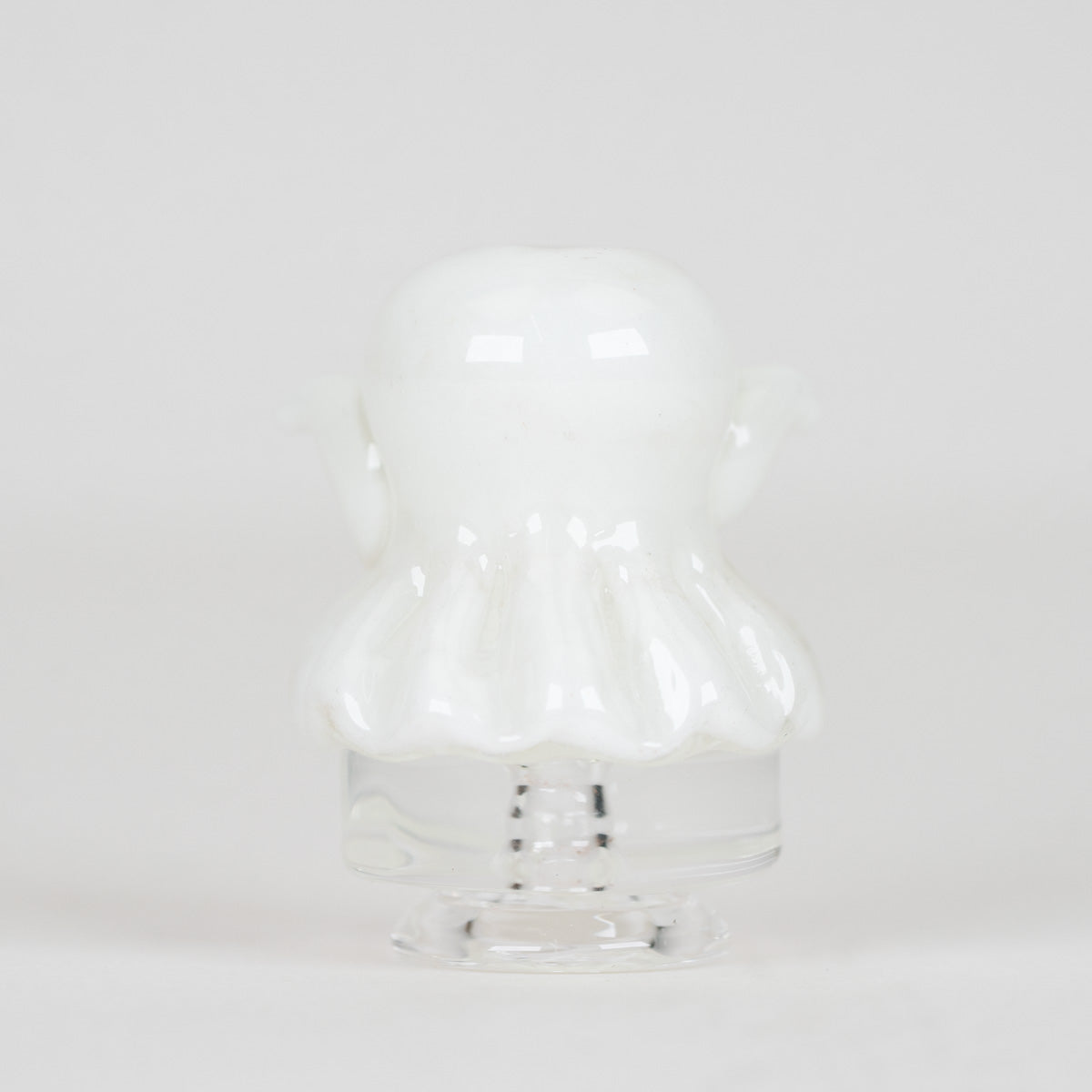 Close-up of the sculpted white ghost and expressive face on the glass mouthpiece
