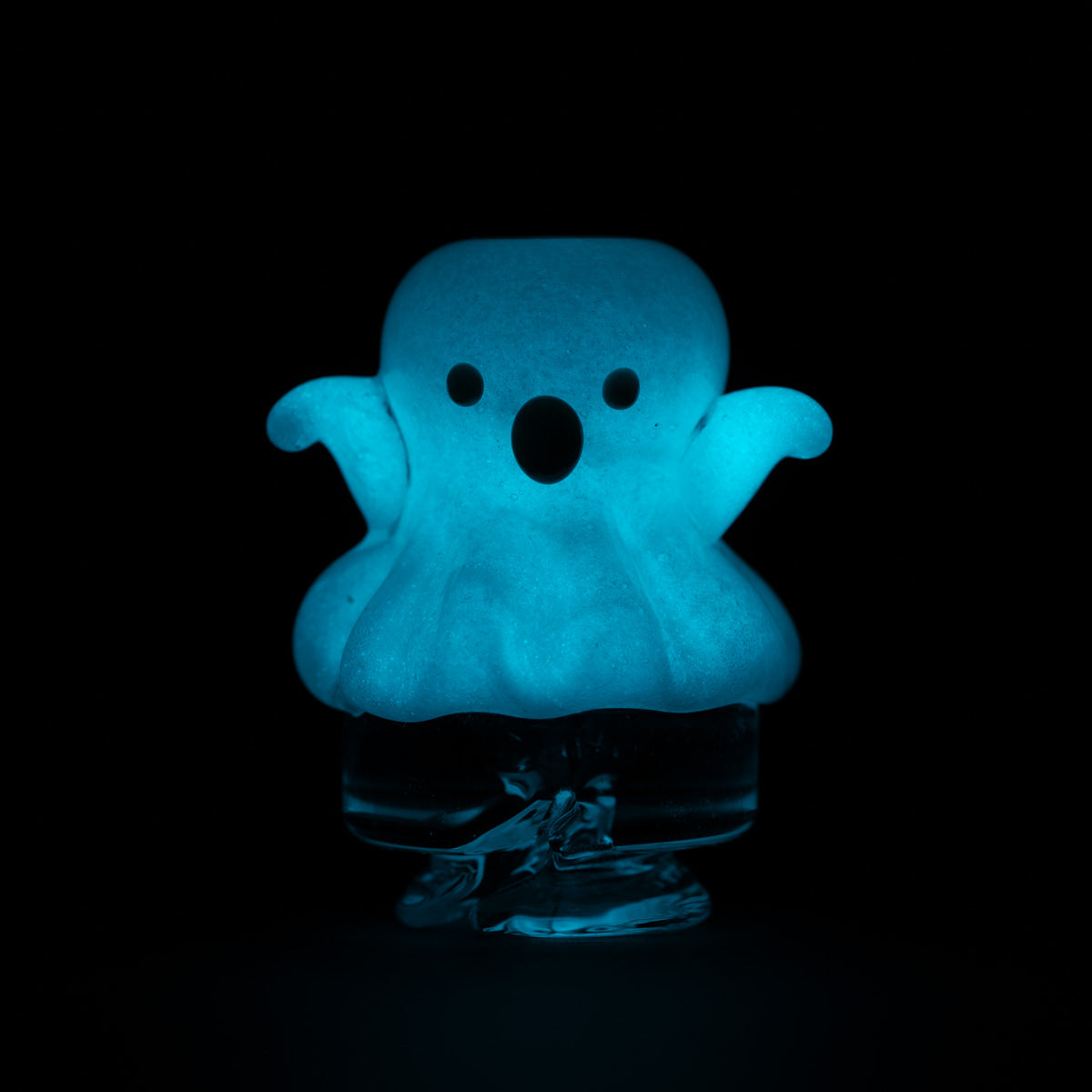 Glow in the dark Puffco Pivot Top on a dark black background