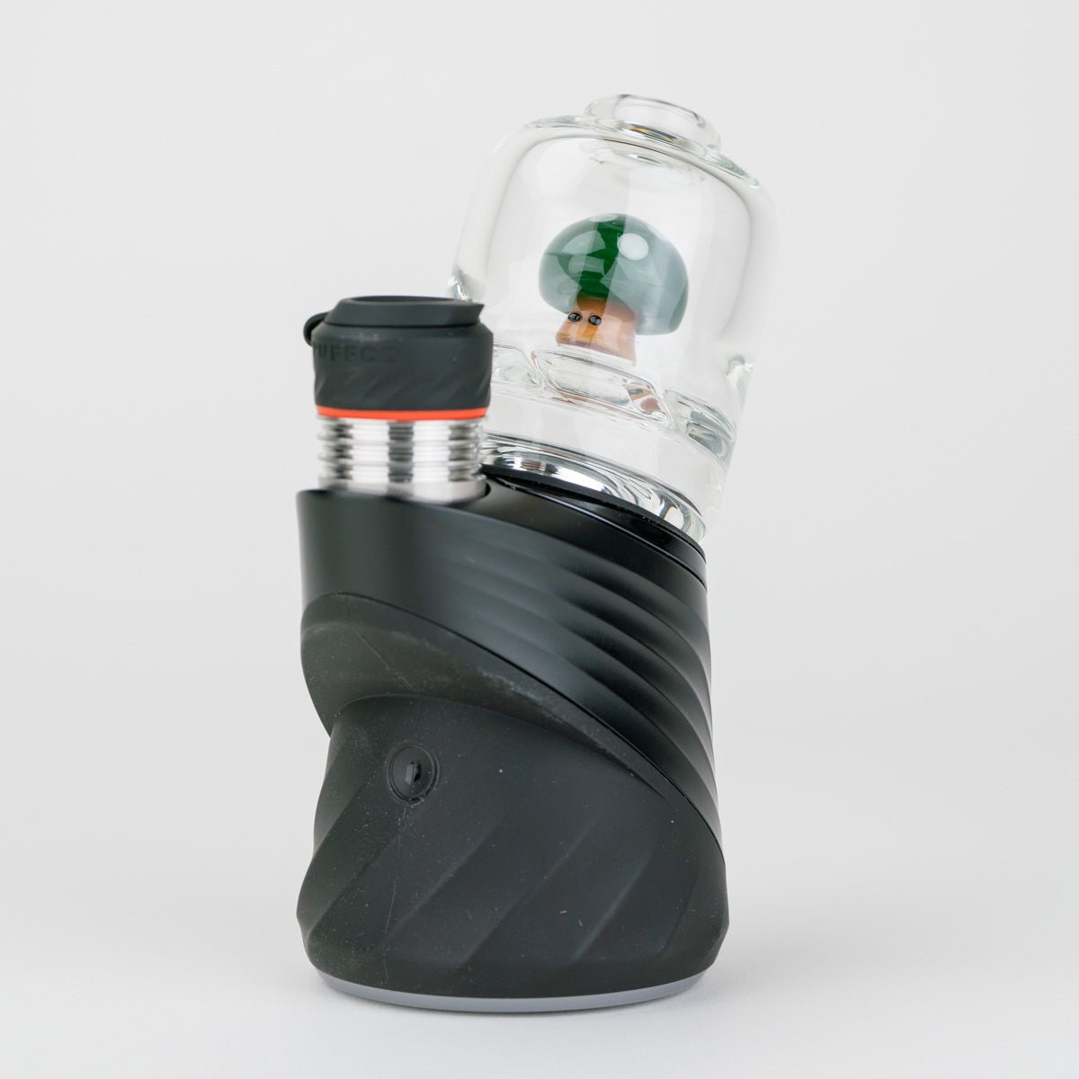 Front view of the green mushroom Puffco glass dry attachment with green mushroom, white spot accents, and clear casing