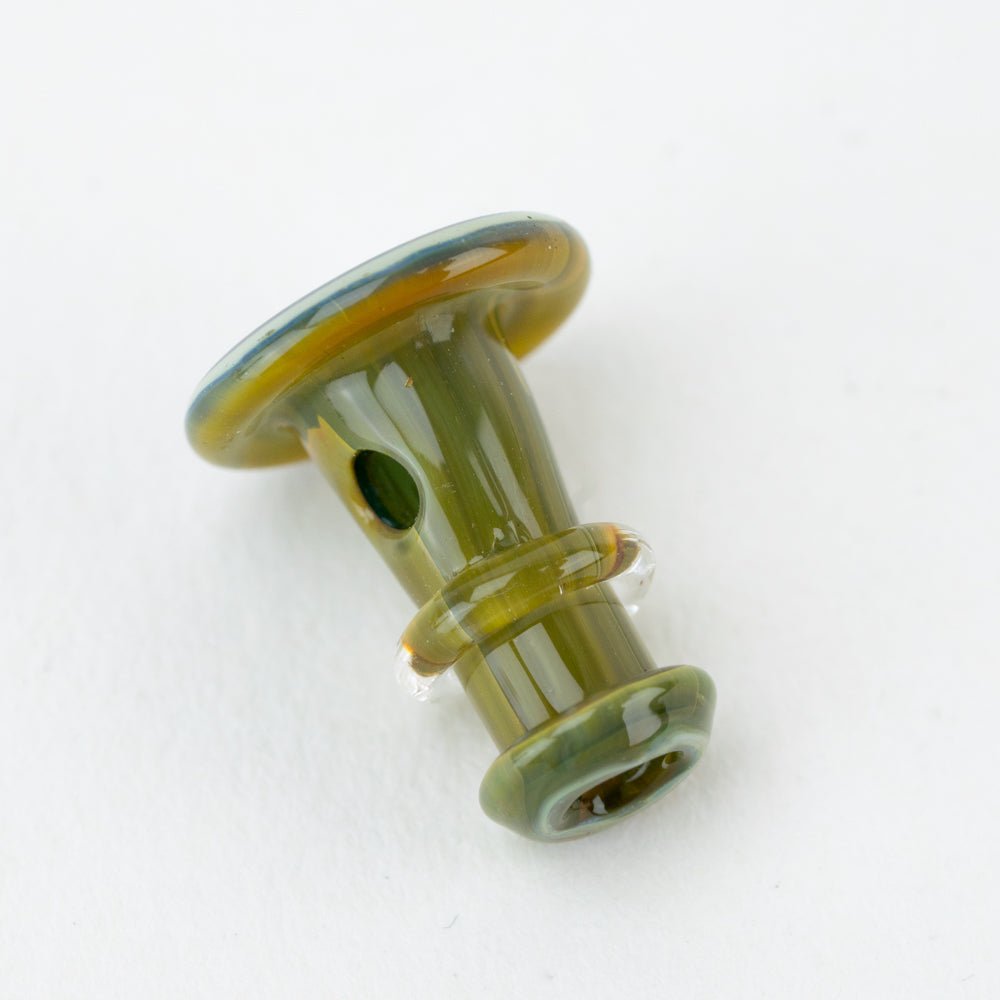 Close-up of green Puffco joystick cap with handcrafted glass detail