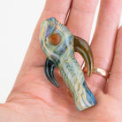 Hazey Oasis Arrowhead chillum held in hand showing size and sculpted form