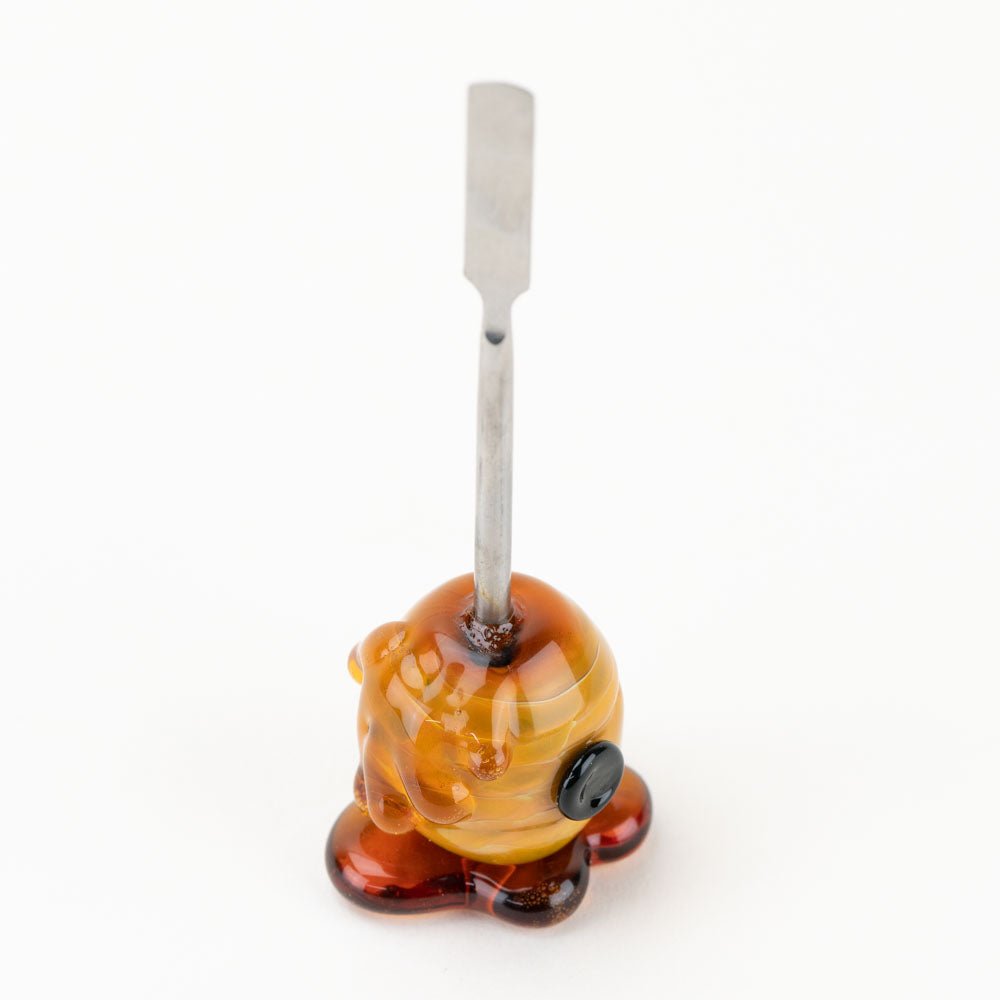Honeycomb glass dabber tool with amber honey-inspired handle design