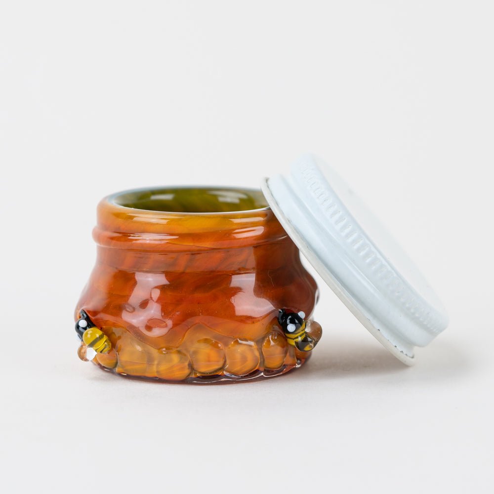 Honeycomb glass terp jar designed for concentrate storage with a warm amber finish and a metal food-safe lid