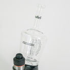 Glass water bottle with a black cap on a white background