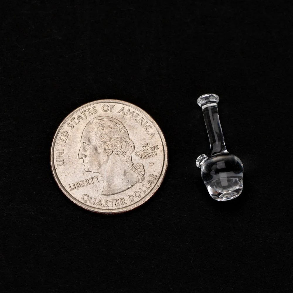 A lego bong next to a quarter for comparison