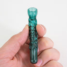 Teal borosilicate glass pinch hitter chillum held in hand