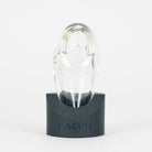 Macusi Auroras clear handmade glass pipe on black, branded stand on white background