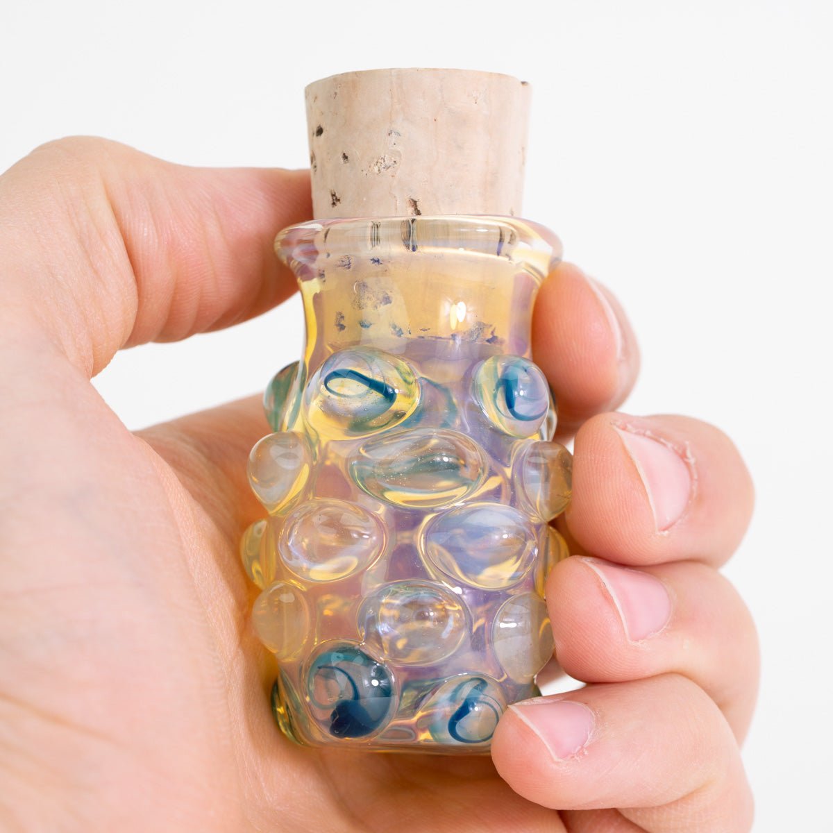 Handheld silver fumed glass storage jar with cork top
