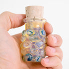 Handheld silver fumed glass storage jar with cork top