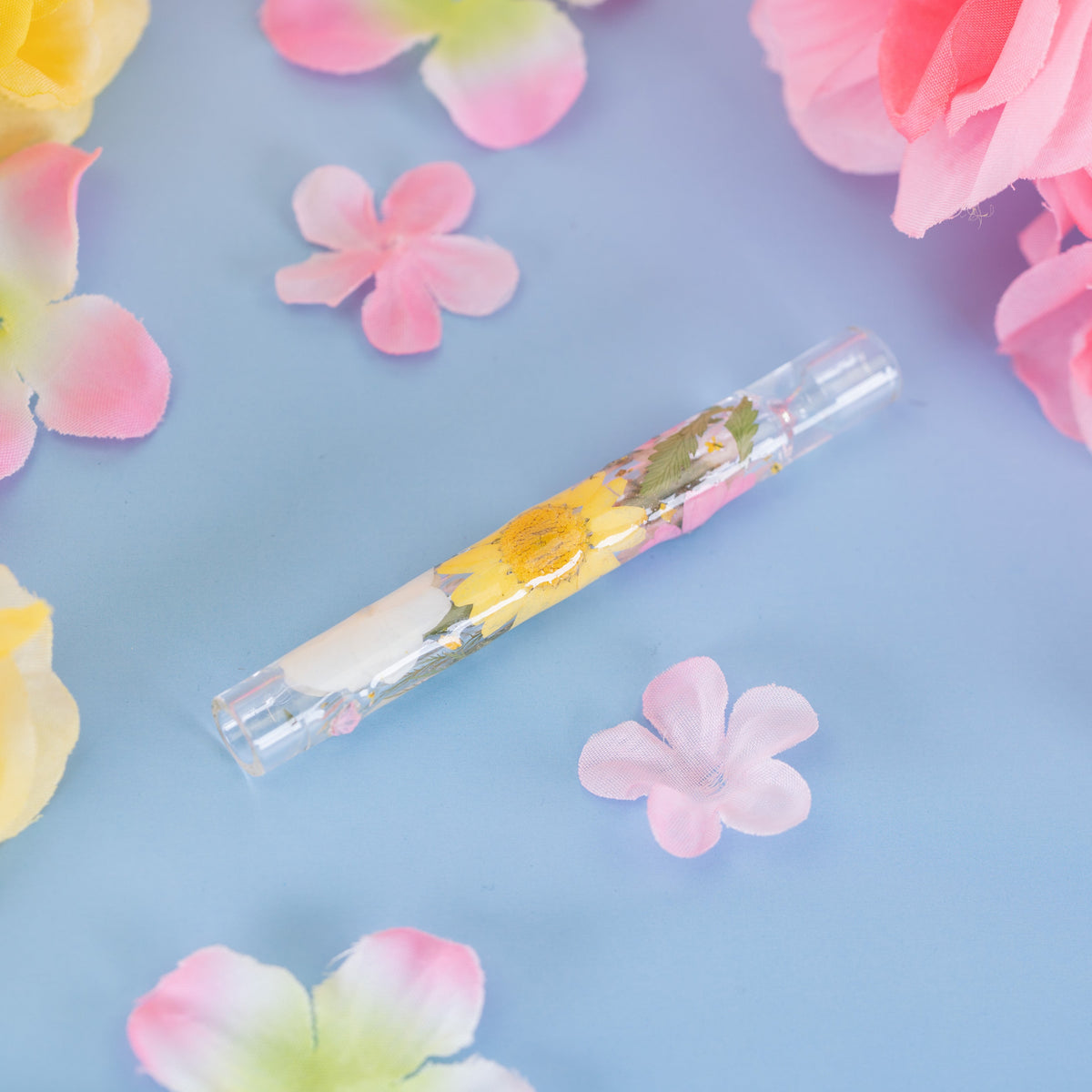 Decorative chillum with pressed flowers on glass