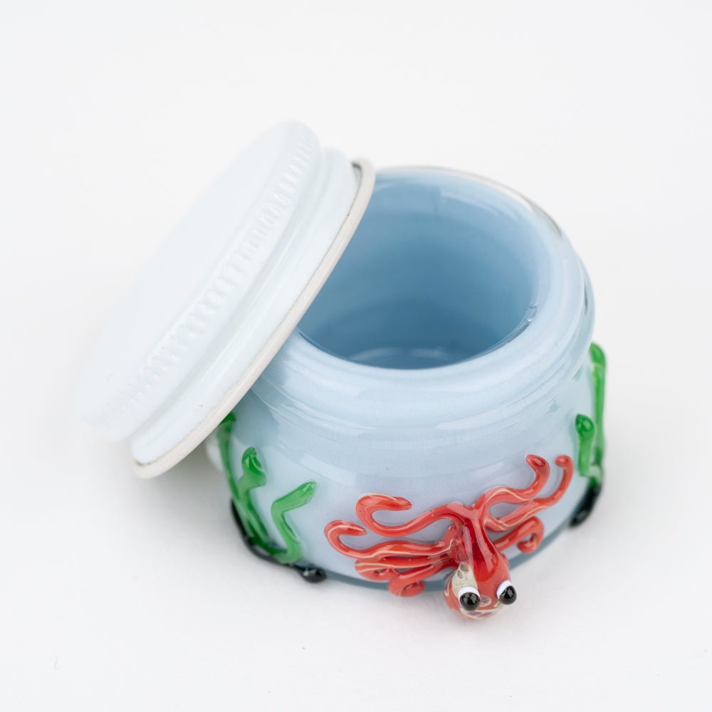 Glass concentrate jar featuring a red octopus design and underwater scene