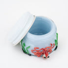 Glass concentrate jar featuring a red octopus design and underwater scene