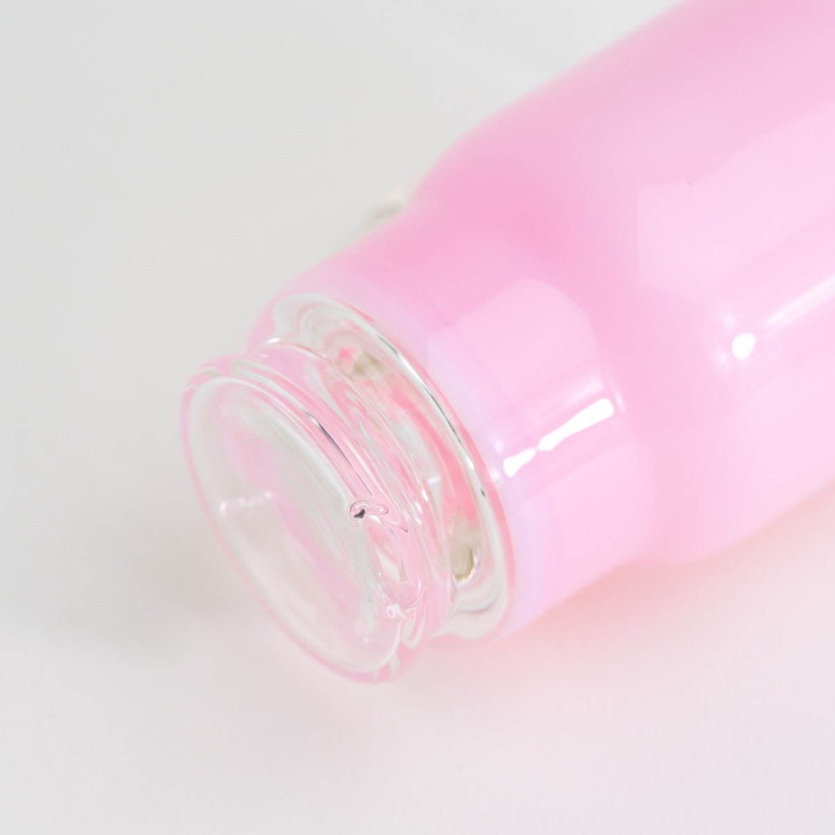 Pink water attachment for Puffco Peak with a playful tumbler design shown from the bottom