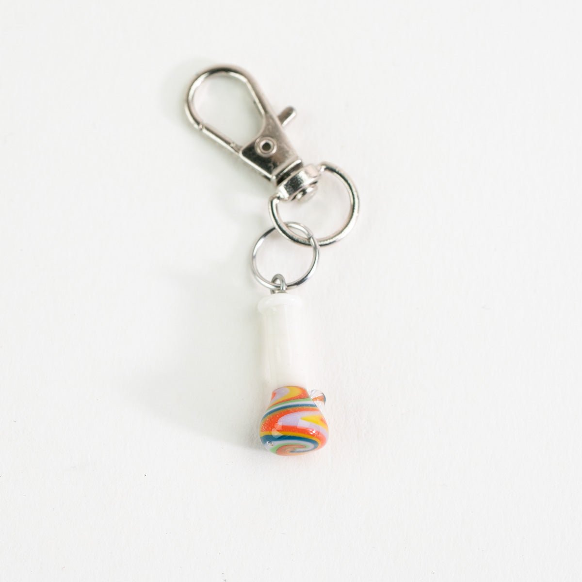 Psychedelic bong charm displayed on a Puffco case for everyday carry