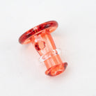 Close-up of a red Puffco joystick cap with translucent glass color