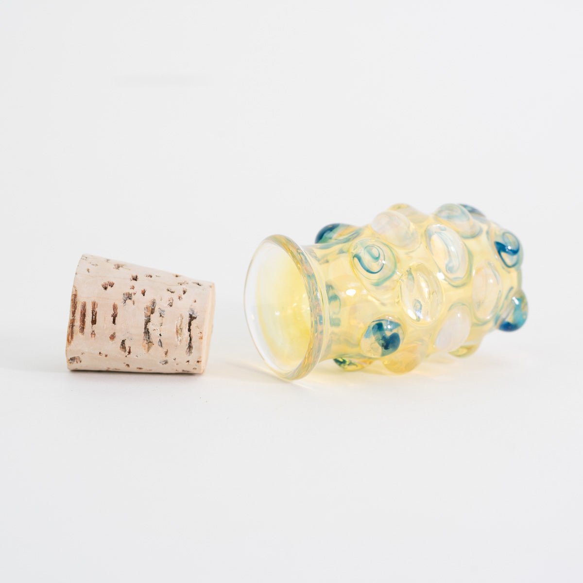 Close up of blue marble accents on fumed glass jar