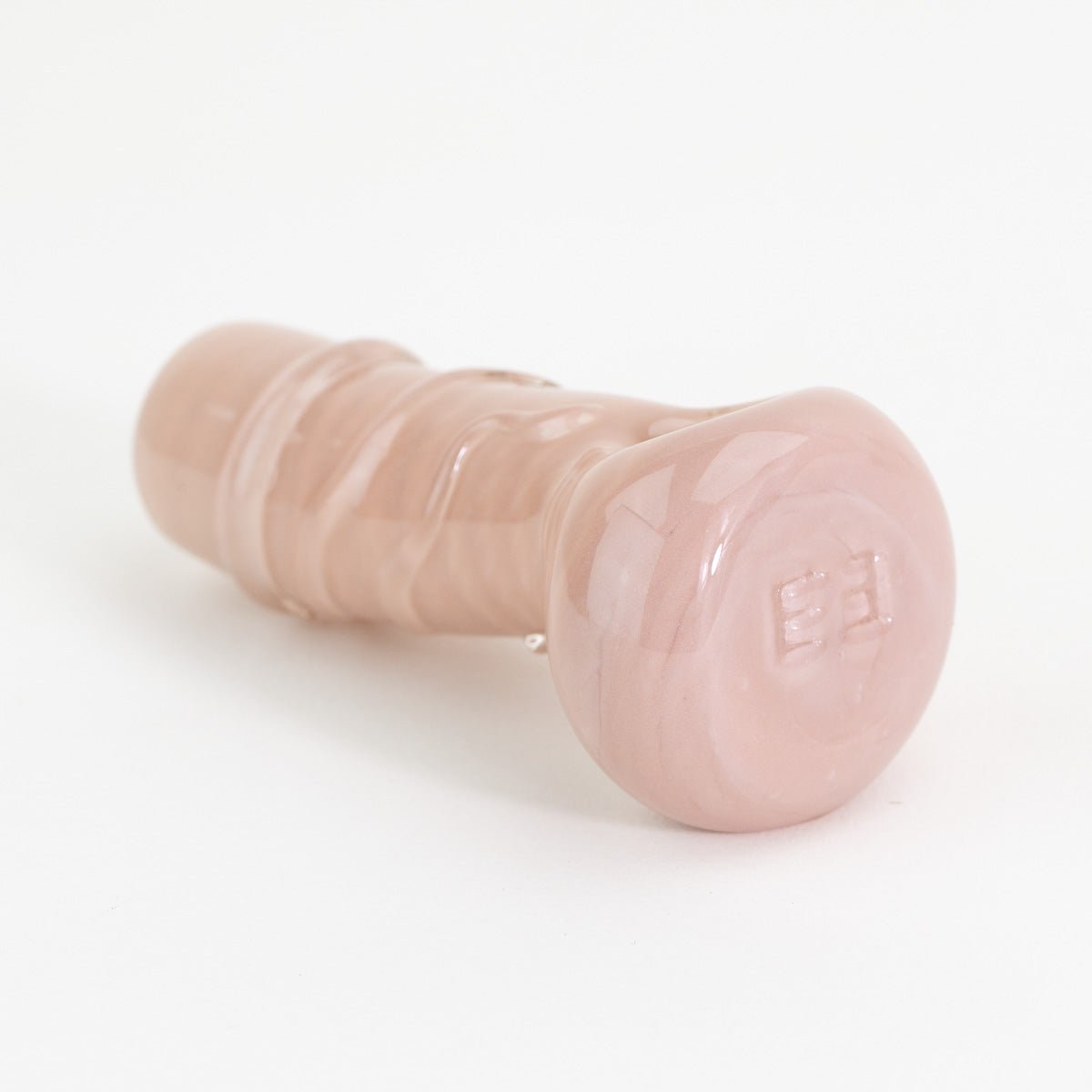 Pink glass penis pipe on white background