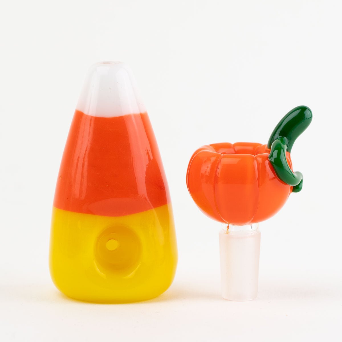 Candy corn-themed dry pipe and pumpkin-shaped bong bowl piece on a white background