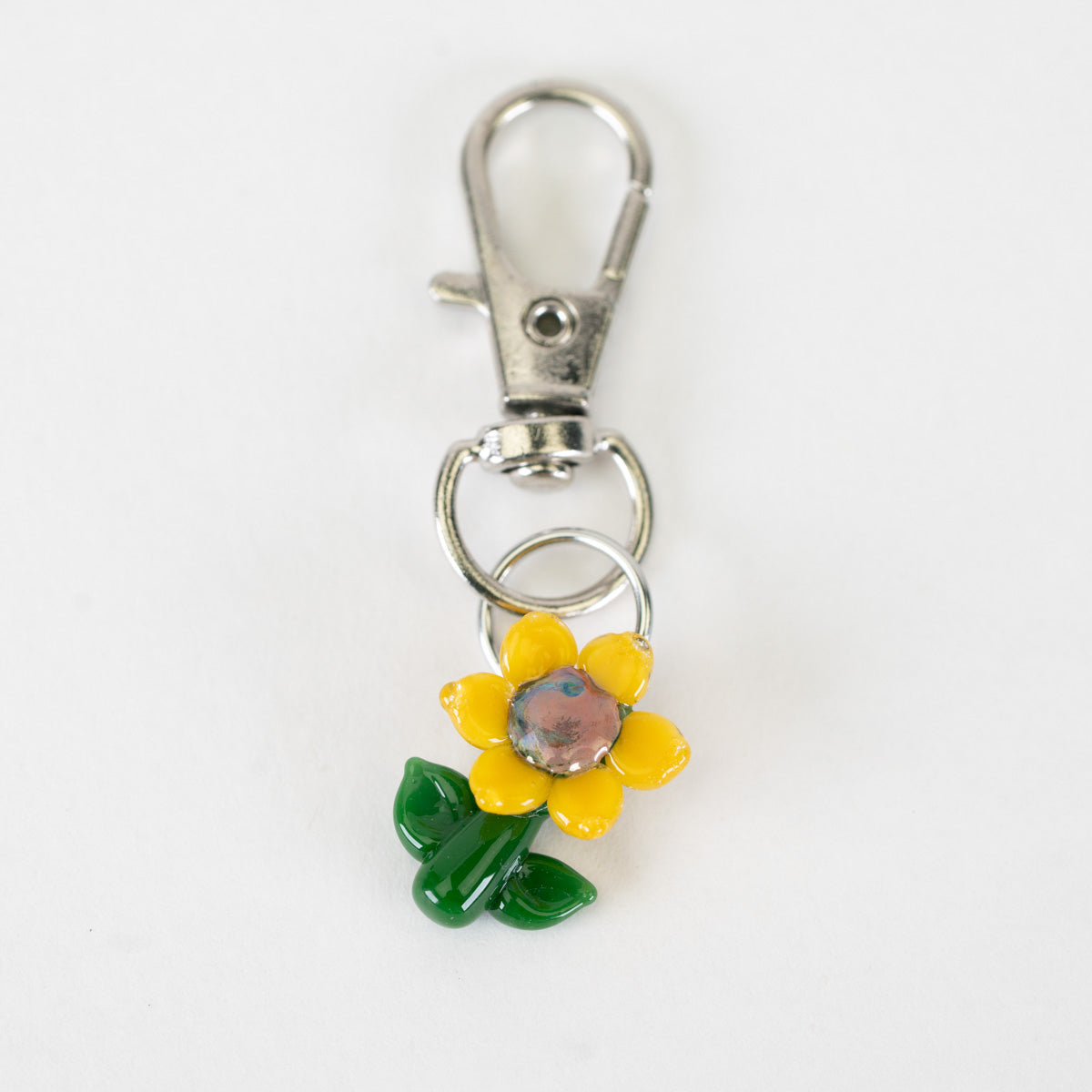 Sunflower glass Puffco charm with yellow petals and green leaves
