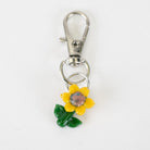Sunflower glass Puffco charm with yellow petals and green leaves