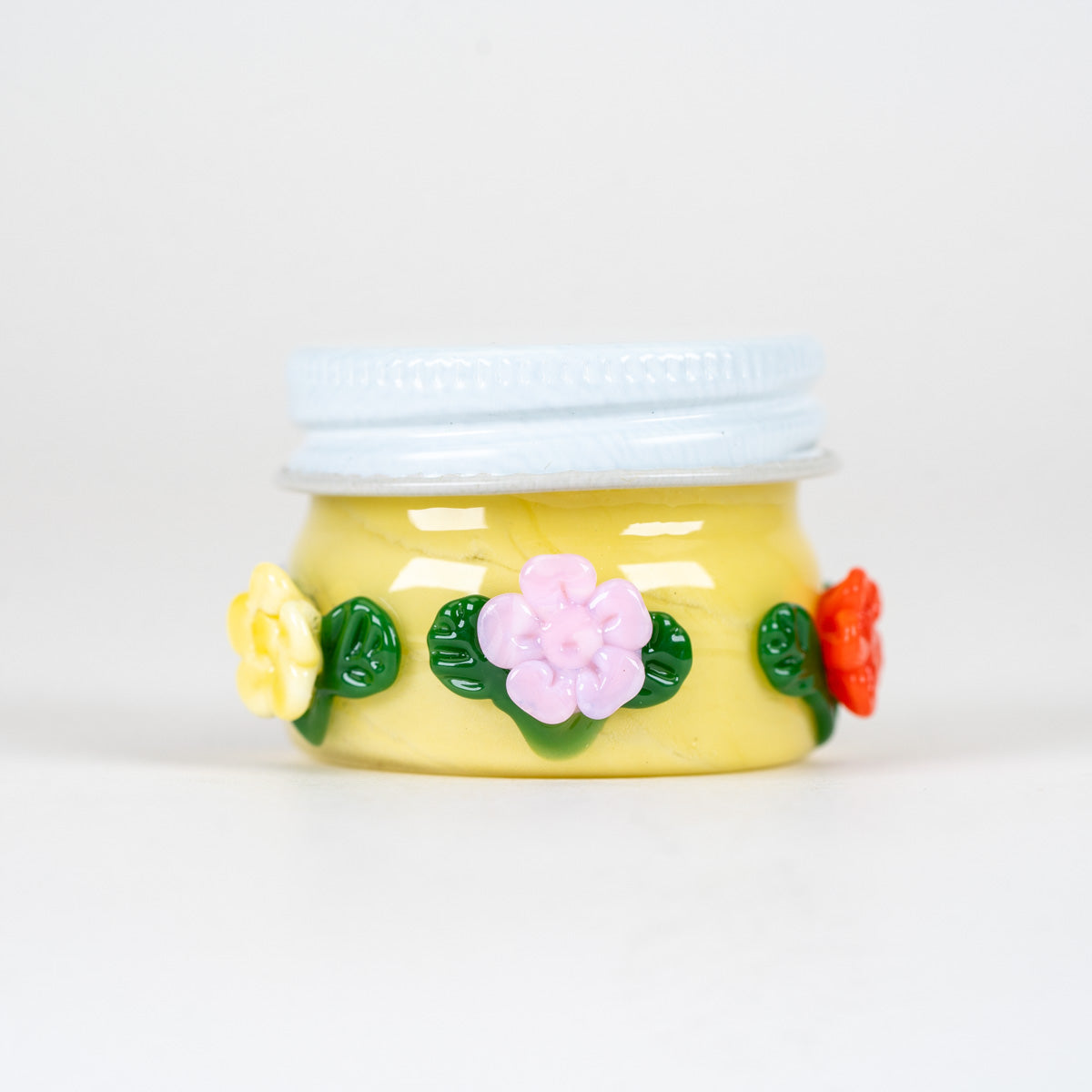 A decorative sunshine inspired terp jar for dabbing and smoking needs