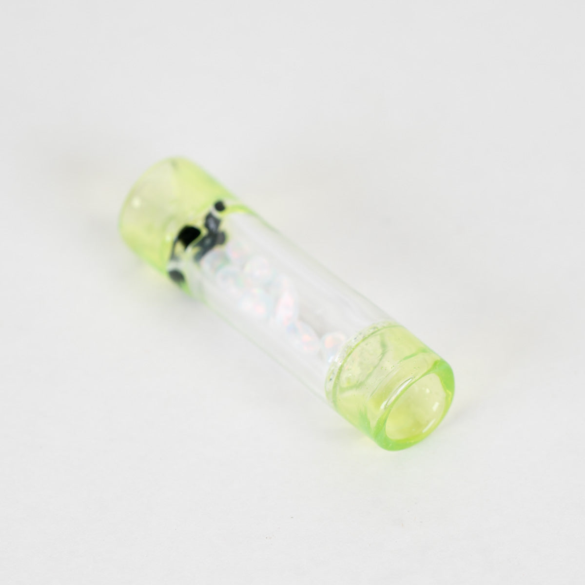 A clear glass rolling tip with shades of green, black, and clear
