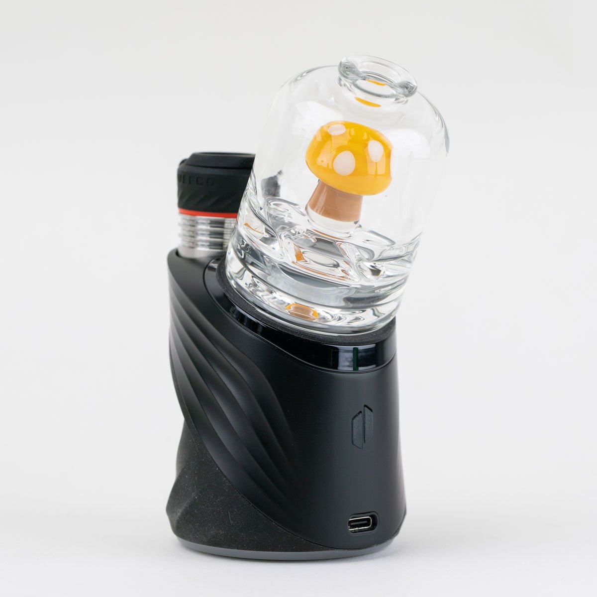 Back view of the yellow mushroom Puffco glass attachment with white spot accents and clear body installed on a black Puffco Peak Pro device